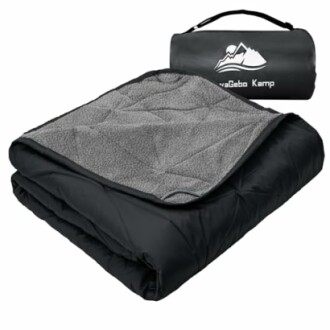 Black camping blanket with gray fleece lining and carrying bag.