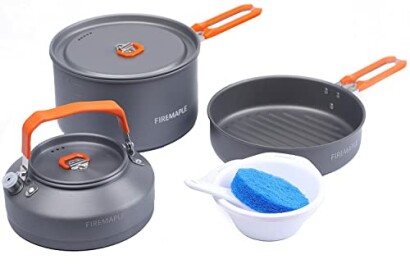 Camping cookware set with pot, pan, kettle, and cleaning sponge.