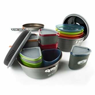 Camping cookware set with pots, lids, and colorful containers.