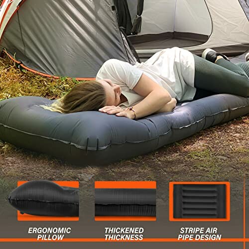 Person lying on an inflatable camping mattress outdoors.