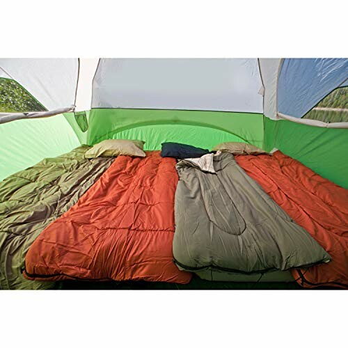 Interior of a tent with three sleeping bags and pillows.