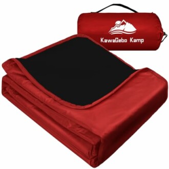 Red camping blanket folded with carry bag