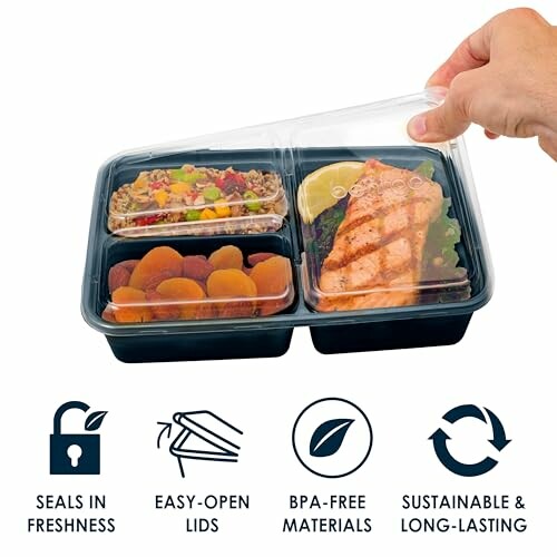 Hand holding meal prep container with compartments of food.