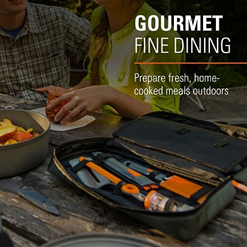 People dining outdoors with cooking tools and prepared food on a picnic table.