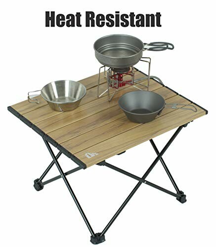 Portable camping table with cookware and heat resistant text.