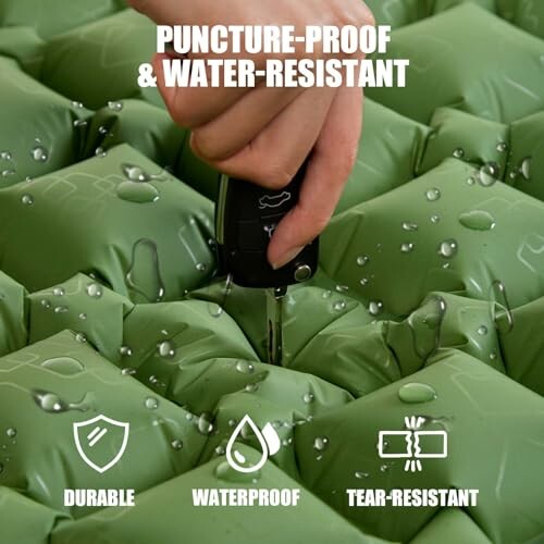 Hand testing puncture-proof and water-resistant air mattress.