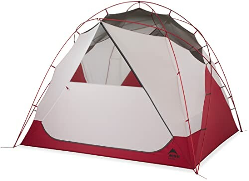 Red and white camping tent with open entrance.