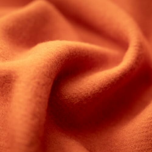 Close-up of soft orange fabric with folds