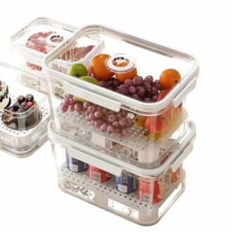 Stacked transparent food storage containers with fruits and drinks.