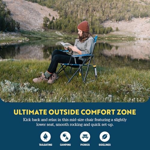 Woman reading in a camping chair by a lake surrounded by nature